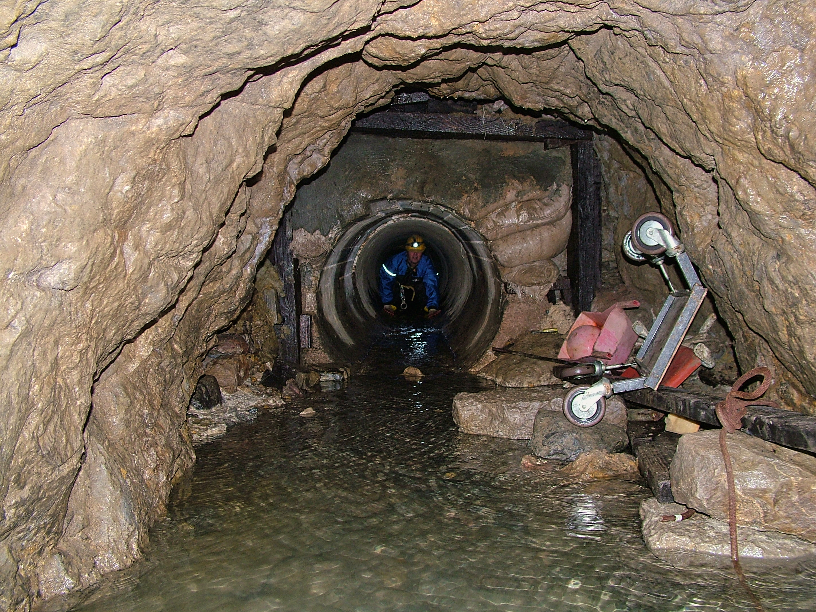 Paul emerging from the concrete lining pipes into the adit